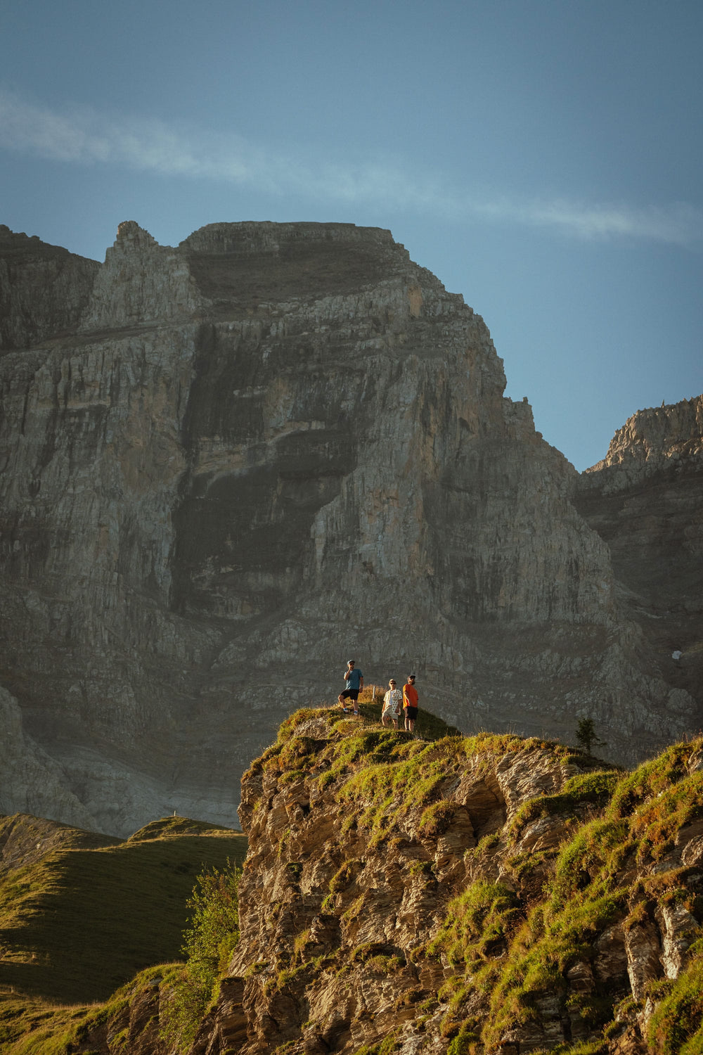 A group of hikers wearing an assortment of 686 clothing, pictured out in the distance as they hike summertime alps trails.