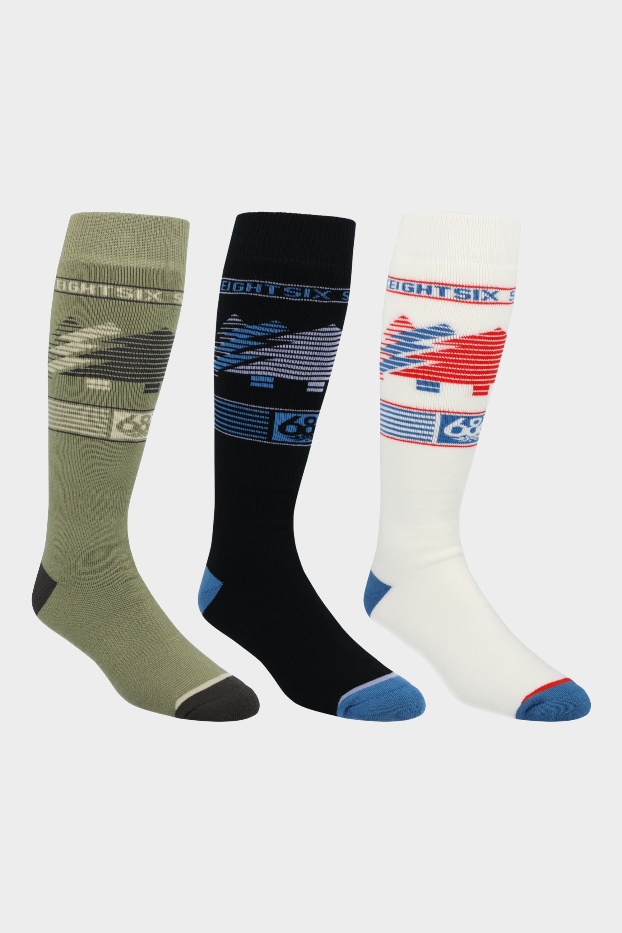 The 686 Mens Treelife Sock (3-Pack) features knee-high socks in green, black, and white with digital graphics and stripes near the top. Made with quick-dry fabric by 686, they are perfect for rides and come displayed side by side on a white background.