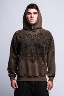 A young man faces forward against a plain light-gray background, wearing the 686 Affliction Natural Rot Pullover Hoody by 686, a brown men’s sweatshirt featuring black intricate designs and "Affliction" on the chest.