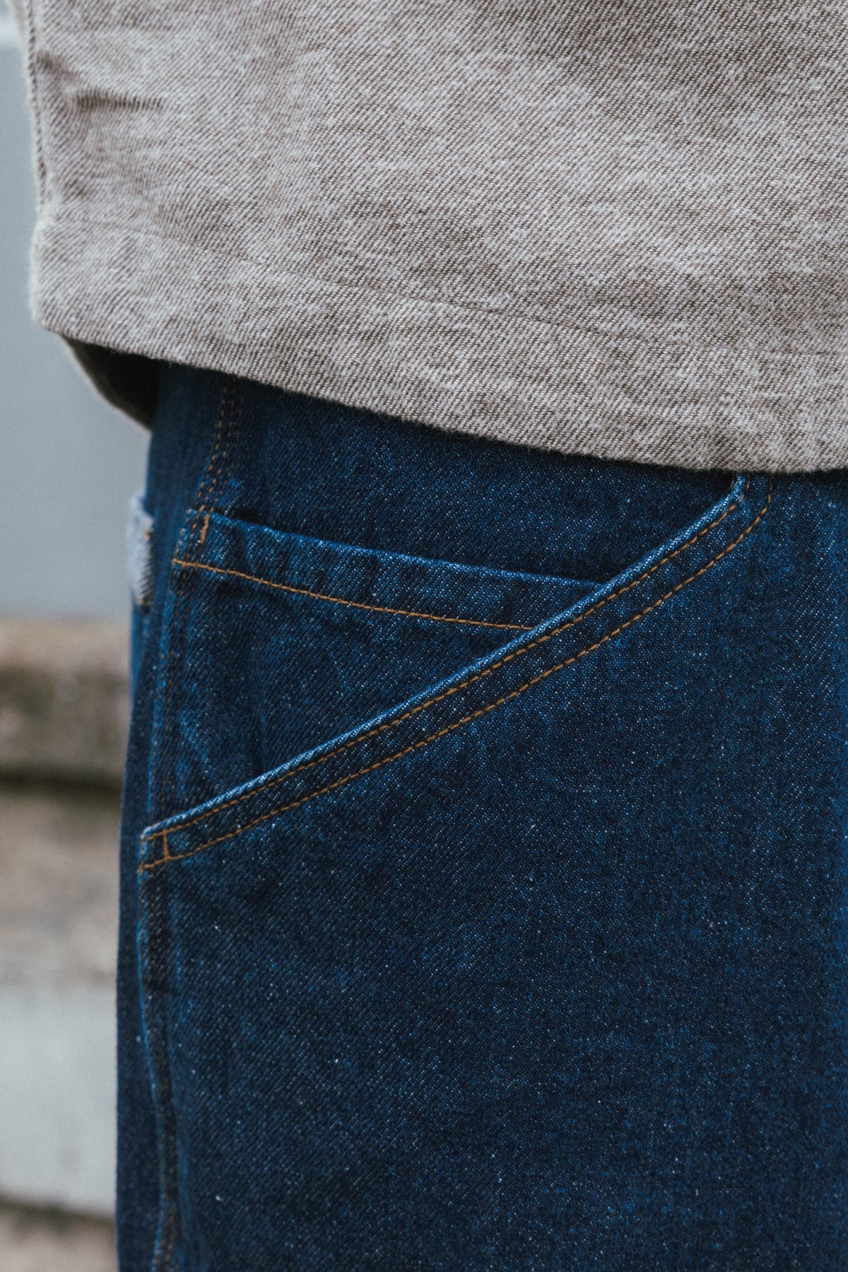 Close-up of 686 Men’s Unwork® Hammerhead Denim Pant in dark blue, featuring a large, slanted pocket with contrast stitching on heavyweight cotton denim.