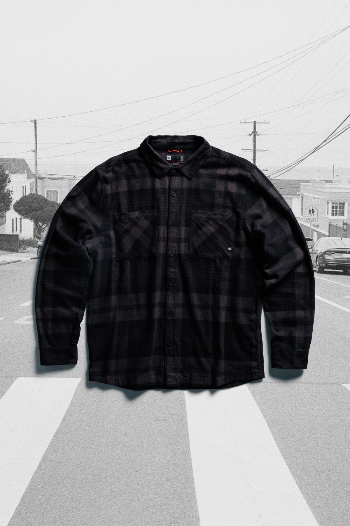 686 Men’s SMARTY® Headwall Flannel: a midweight cotton, long-sleeve, button-down shirt in a dark grey and black plaid pattern with two chest pockets.
