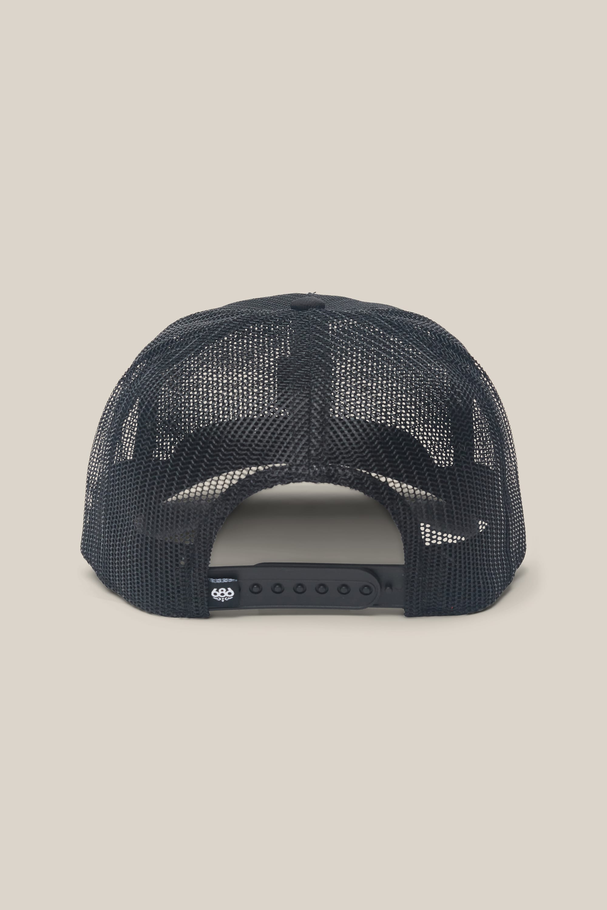 The image displays the back of the 686 High-Pro Knockout Structured 5 Panel Hat by 686—a black mesh trucker hat featuring an adjustable snapback closure—set against a plain beige background. This men's hat blends classic mesh construction with contemporary comfort and versatility.