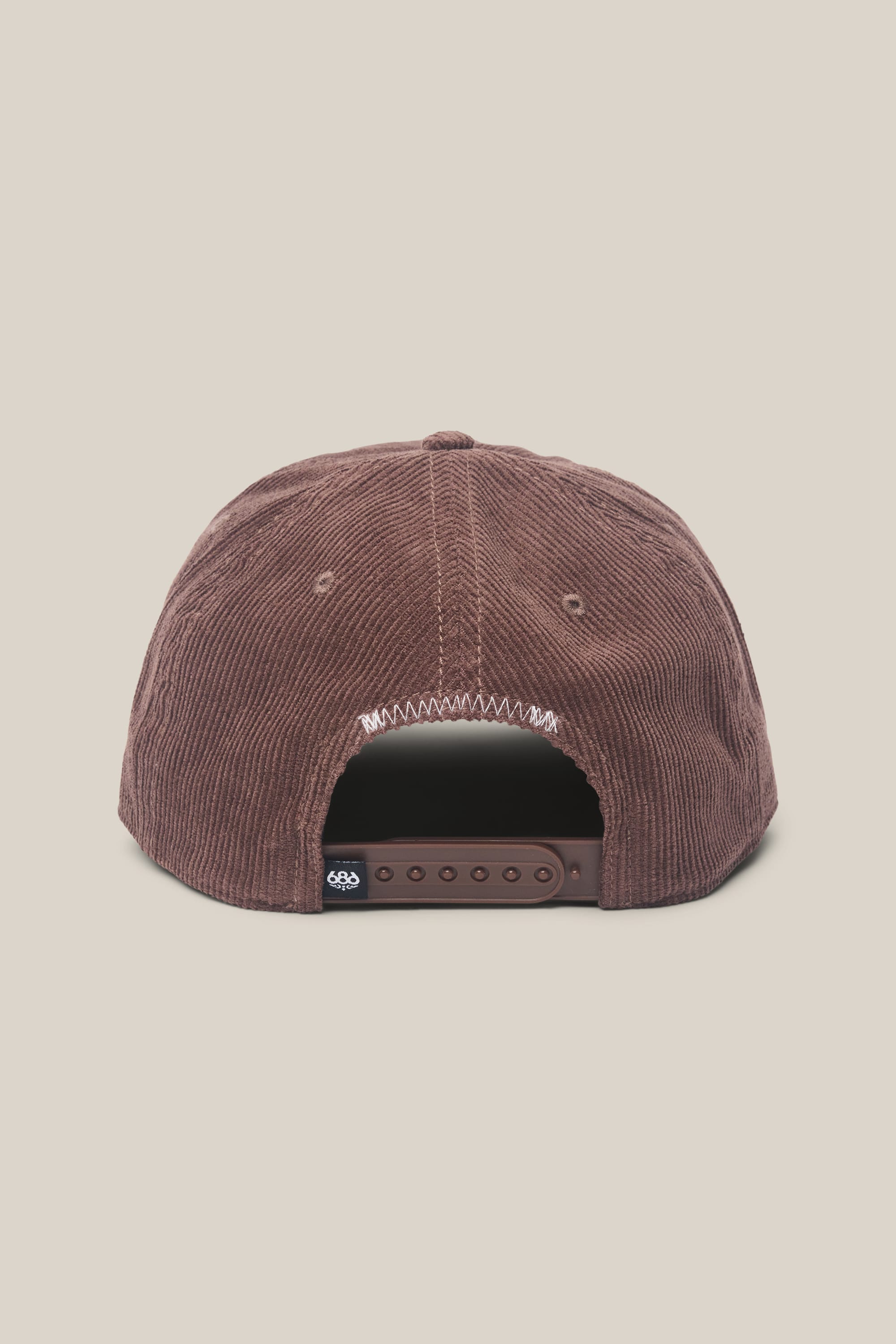Back view of the 686 Mid-Pro Ghost Cord Unstructured 5 Panel Hat in brown corduroy, featuring an adjustable snapback and a small black tag above the strap, by 686, set against a neutral background.