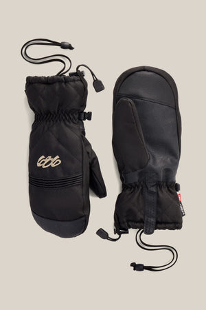 Two 686 Women’s Jubilee™ Mitts in black are displayed on a neutral background, showing both the palm and back sides. One mitten features stitched detailing and a small embroidered 686 logo, with drawstring cords for insulation.