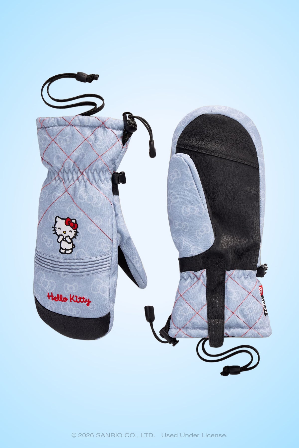 A pair of light blue 686 Women’s Jubilee™ Mitts by 686, featuring black palms, pink stitching, a Hello Kitty character, and Hello Kitty text on the cuffs—these vintage snowboard gloves are displayed on a light blue background.