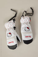 The 686 Womens Jubilee Mitt by 686 features white mittens with red stitching, a Hello Kitty face and logo on the back, waterproof design, black palms, adjustable wrist cords, and light insulation for warmth and comfort.