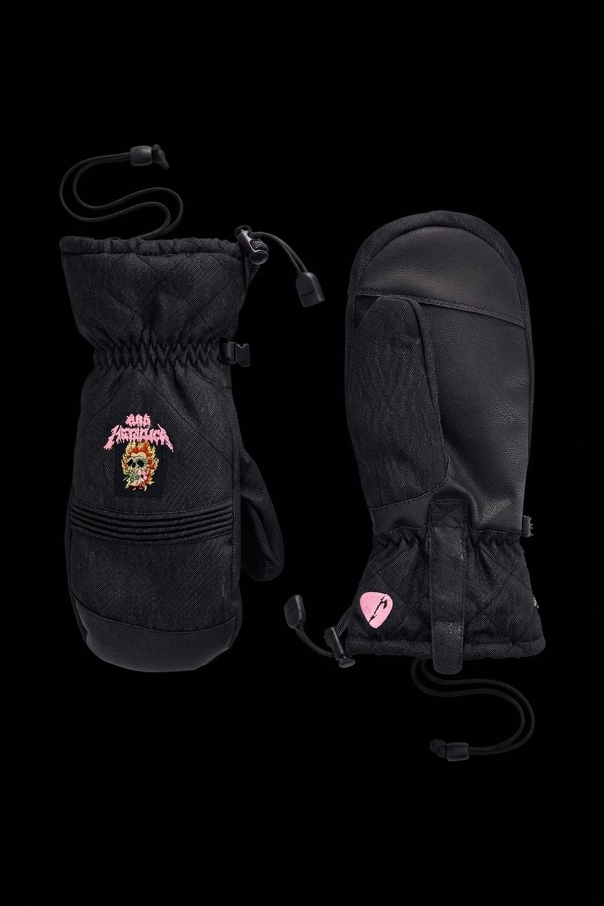 686 Women’s Jubilee™ Mitt pair of black waterproof insulated winter mittens featuring a Metallica skull graphic on the back and a pink guitar pick logo on the wrist strap.