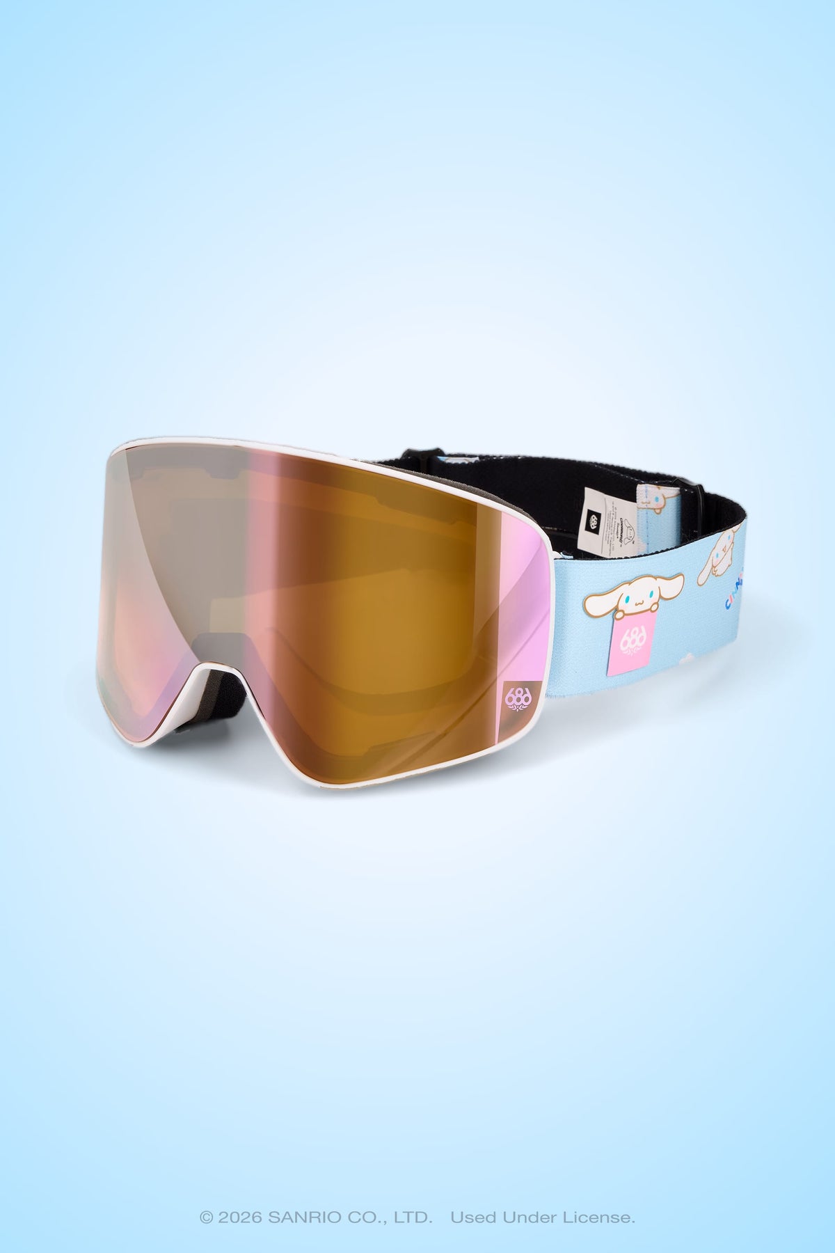 The 686 SMARTY® Magnetic Goggle by 686 features a reflective pink and gold tinted lens, complemented by a light blue strap adorned with an adorable character design and clouds. Designed for full-lens vision, these goggles deliver an expansive view on the slopes. The backdrop is a soft blue gradient.