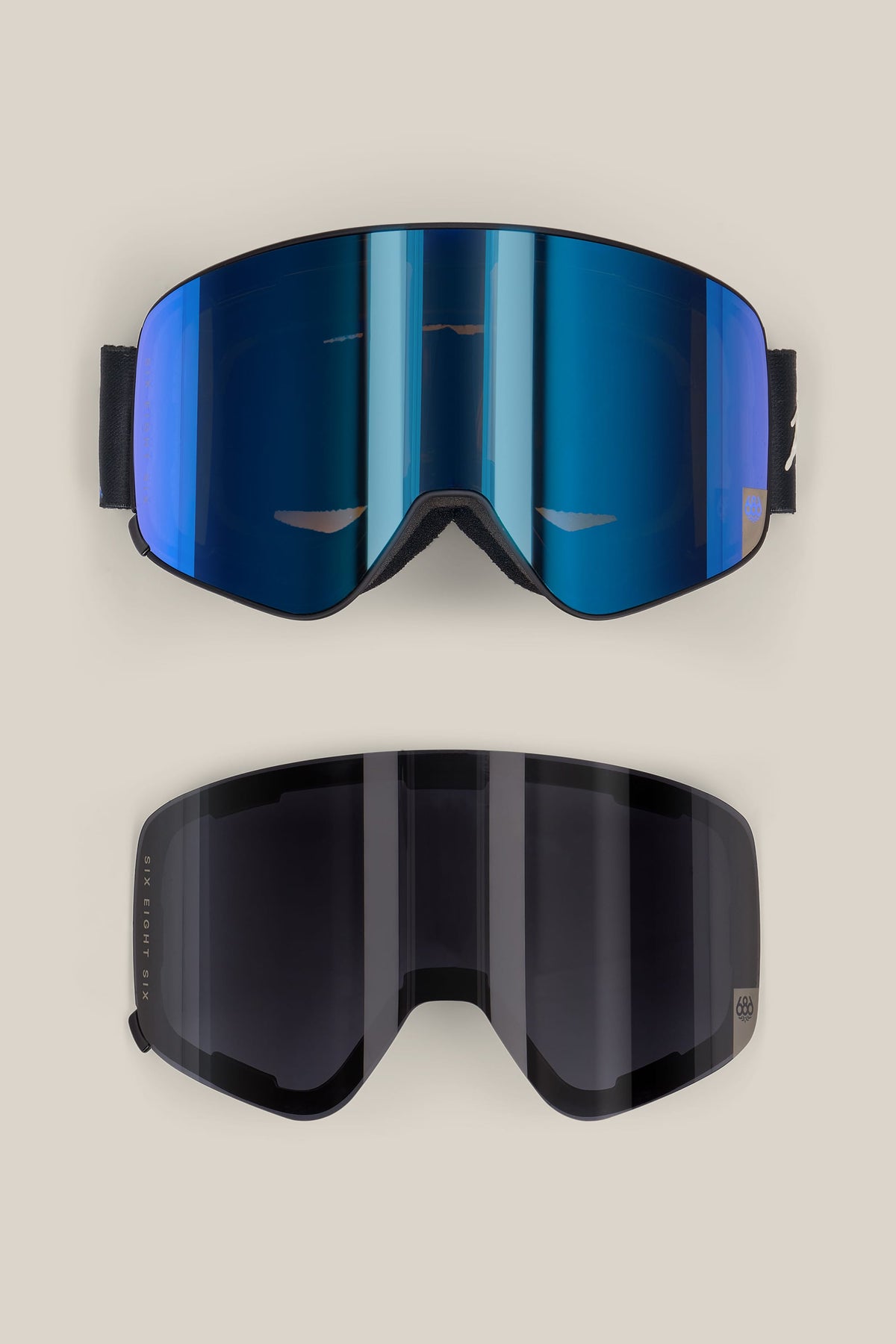 Two 686 SMARTY® Magnetic Goggles shown from the front, one with a reflective blue magnetic lens and the other with a dark grey lens.