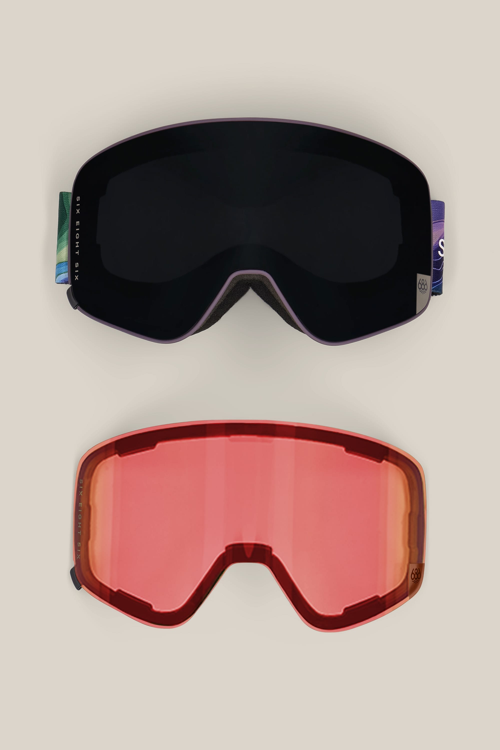 Two pairs of 686 SMARTY® Magnetic Goggles by 686 are displayed on a plain background: the top pair features a dark lens, while the bottom pair has a red-tinted lens.