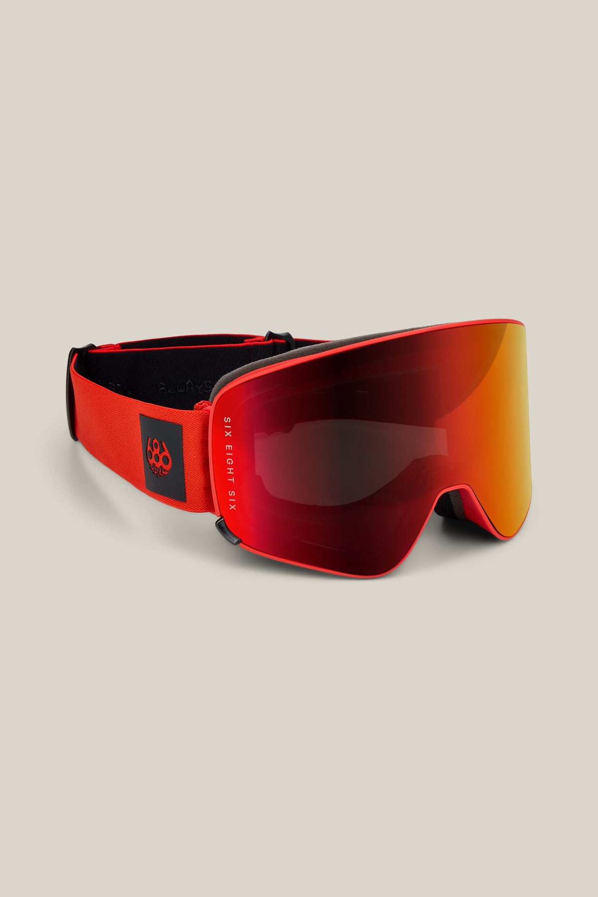 The 686 SMARTY® Magnetic Goggle by 686 features a wide, reflective orange lens and an adjustable red strap, shown on a neutral beige background.