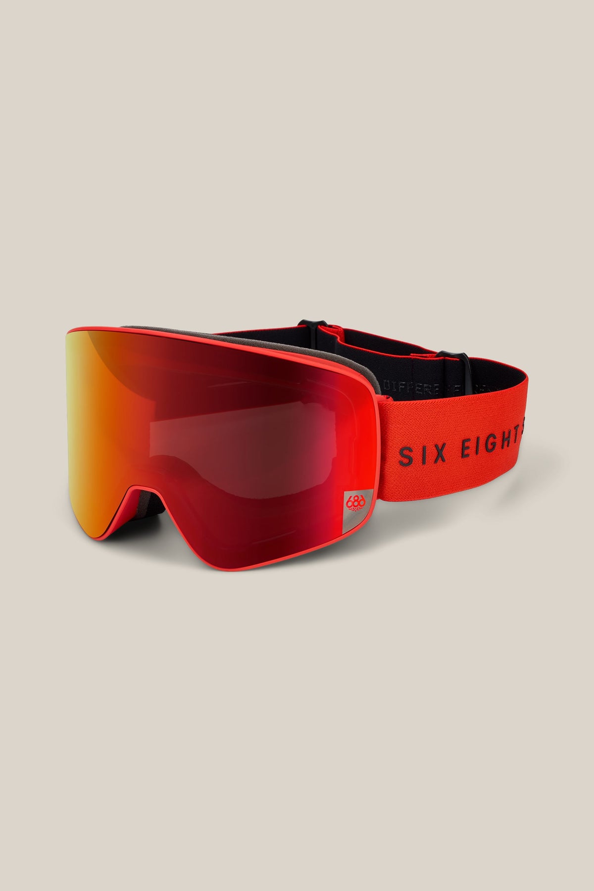 686 SMARTY® Magnetic Goggle in red and orange with a reflective lens, featuring a black adjustable strap and “686” branding in black on the band, displayed on a light beige background.