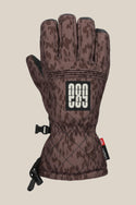 The 686 Womens Jubilee Glove features a brown camouflage PU exterior, a black and white 686 logo patch on the back, an adjustable wrist strap, and a drawstring cuff closure.