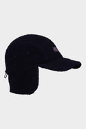 The 686 Fleece Camper Hat by 686 is a black winter cap with ear flaps and a curved brim, displayed in a side view against a plain white background.