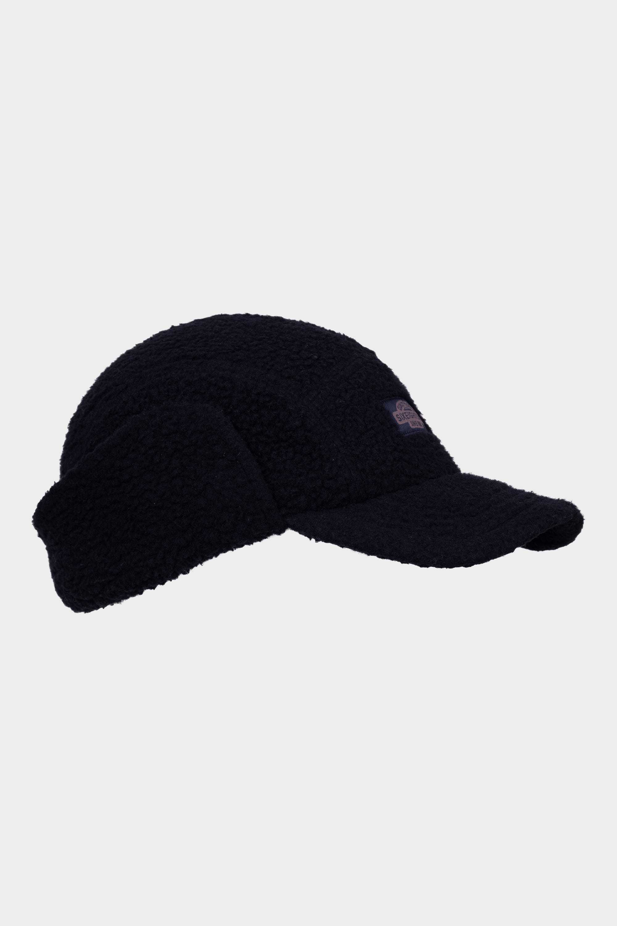 The 686 Fleece Camper Hat by 686 is a black fleece baseball cap with extended ear flaps, displayed against a plain light grey background.