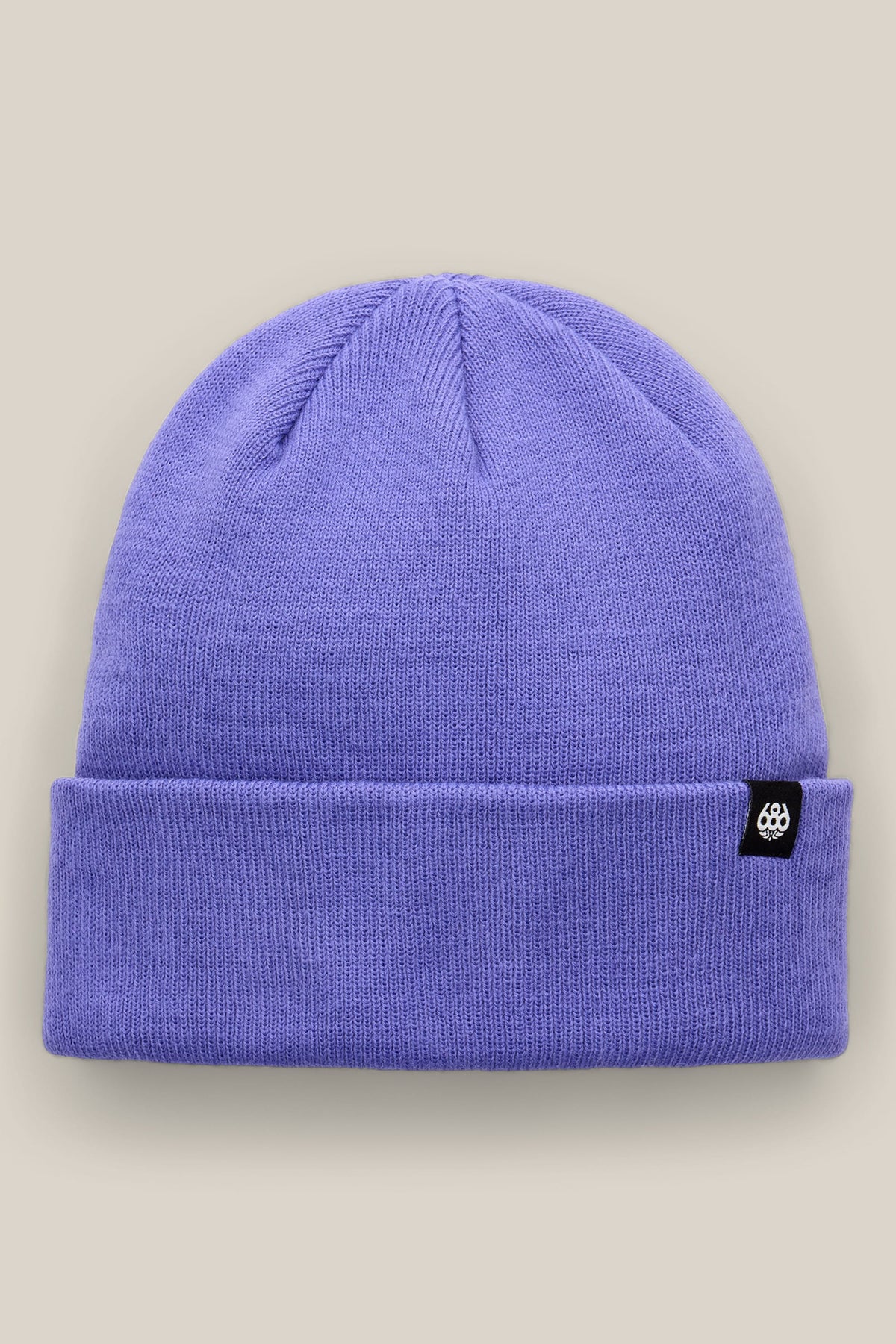 The 686 Standard Roll Up Beanie by 686 is a lavender knit hat featuring a folded brim and a small black tag with a white logo, shown against a light beige background.