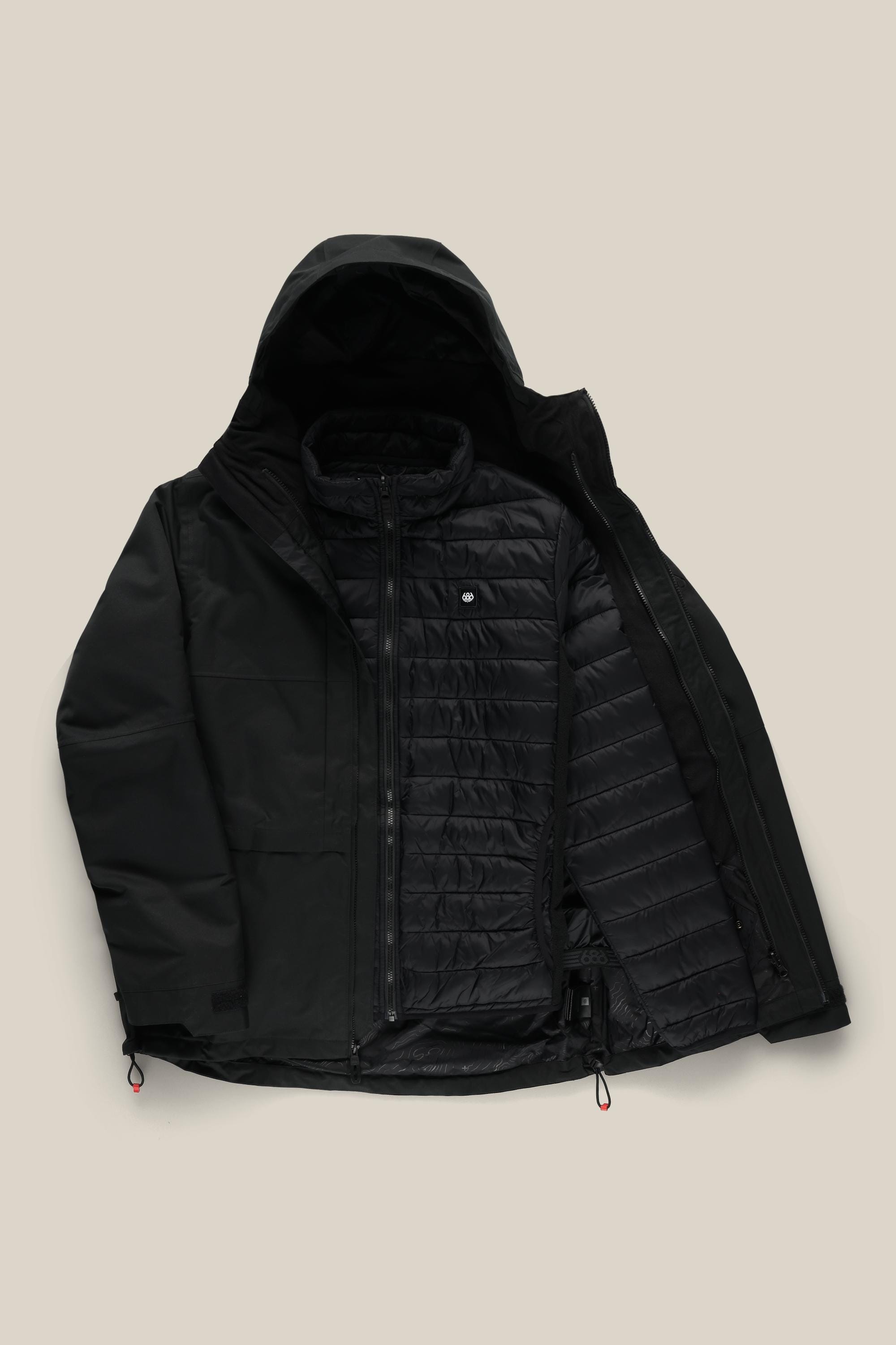 The 686 Mens Smarty 3-In-1 Form Jacket by 686 is shown laid flat on a light beige background, open to display its inner quilted lining and extra zippered layer inside. The black waterproof jacket features a zippered front.