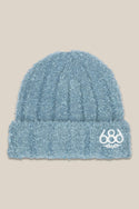 The 686 Women's Fuzzy Beanie is a light blue textured knit hat with a folded brim and white embroidered 686 logo on the front, shown against a plain beige background.