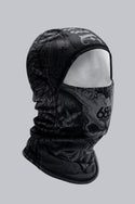 The 686 Affliction Hurra Hinged Balaclava by 686 is a black polyester facemask with a detailed skull and bone pattern, shown on a white mannequin head against a plain gray background.