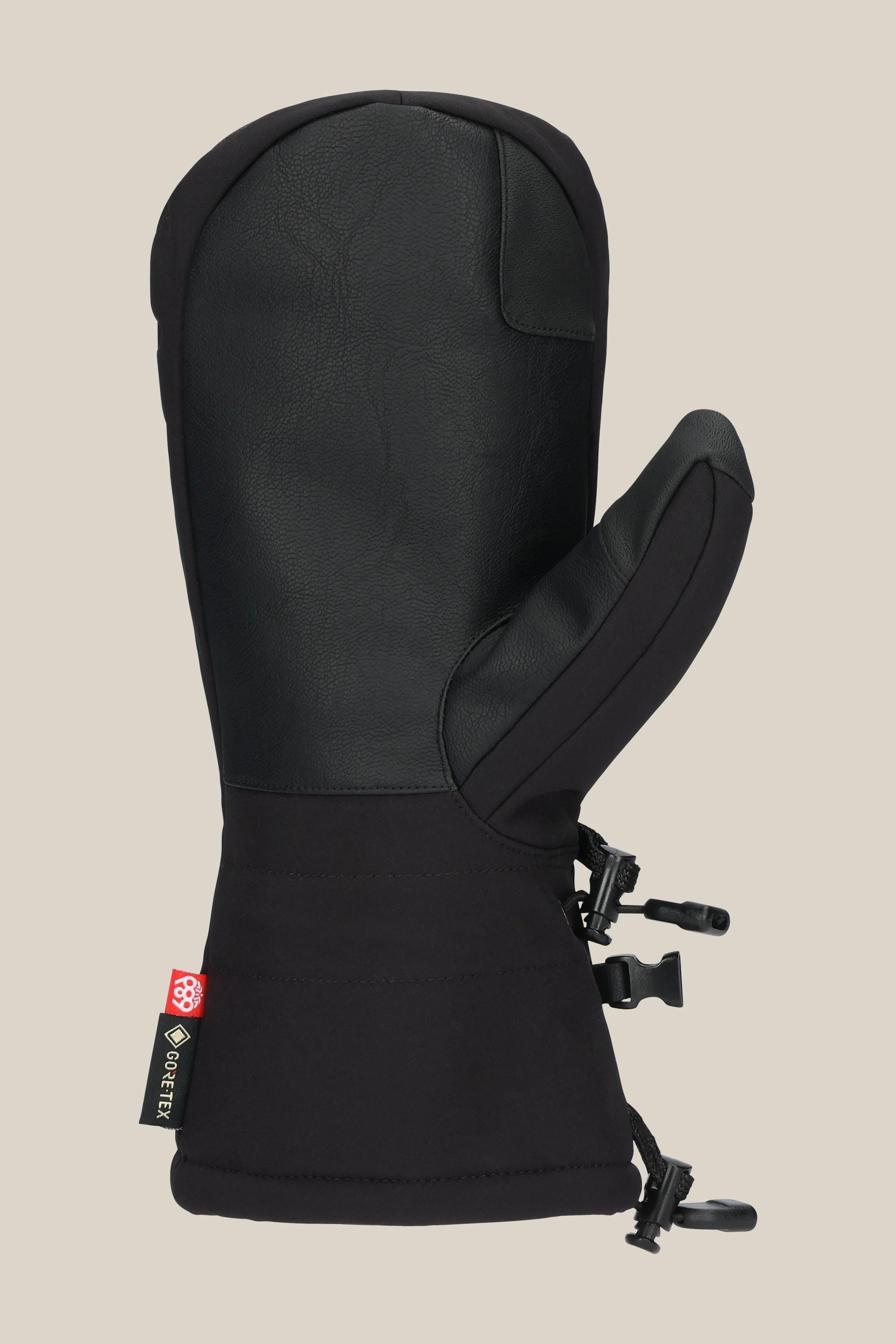 The 686 Mens GORE-TEX Linear Mitt is a black insulated PU mitt featuring a textured grip, adjustable wrist strap, and a branded side tag displaying GORE-TEX info, shown on a plain beige background.
