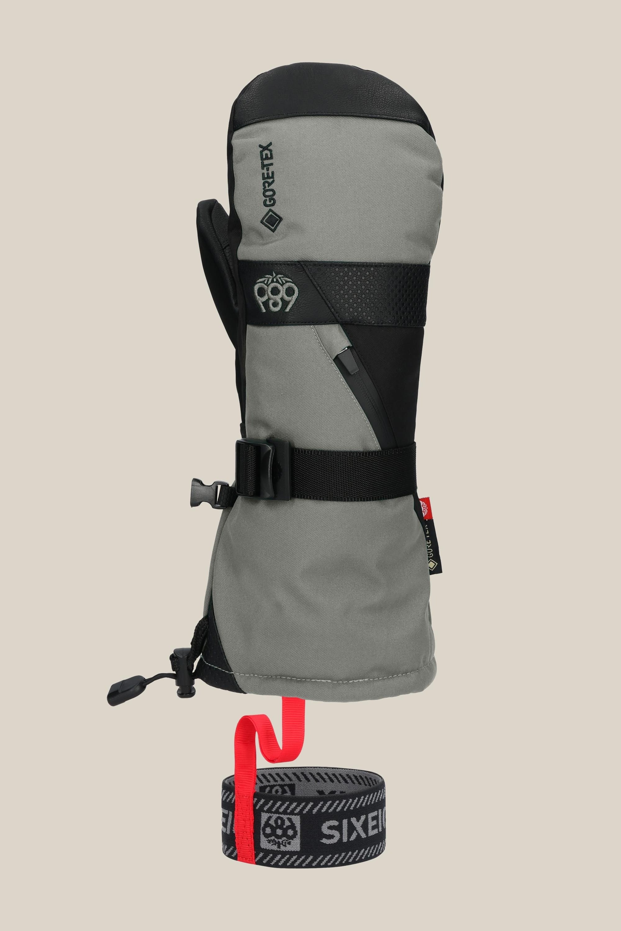 The 686 Mens GORE-TEX Smarty 3-In-1 Gauntlet Mitt is a grey and black insulated PU mitt with a black strap, GORE-TEX branding, and a detachable grey wrist leash with a bold red loop and SIXEIGHT6 text, shown upright on a plain background.