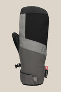 The 686 Mens GORE-TEX Linear Under Cuff Mitt features a black and grey color block design, Velcro wrist strap, Gore-Tex tag, and subtle front branding. Displayed against a plain beige background.
