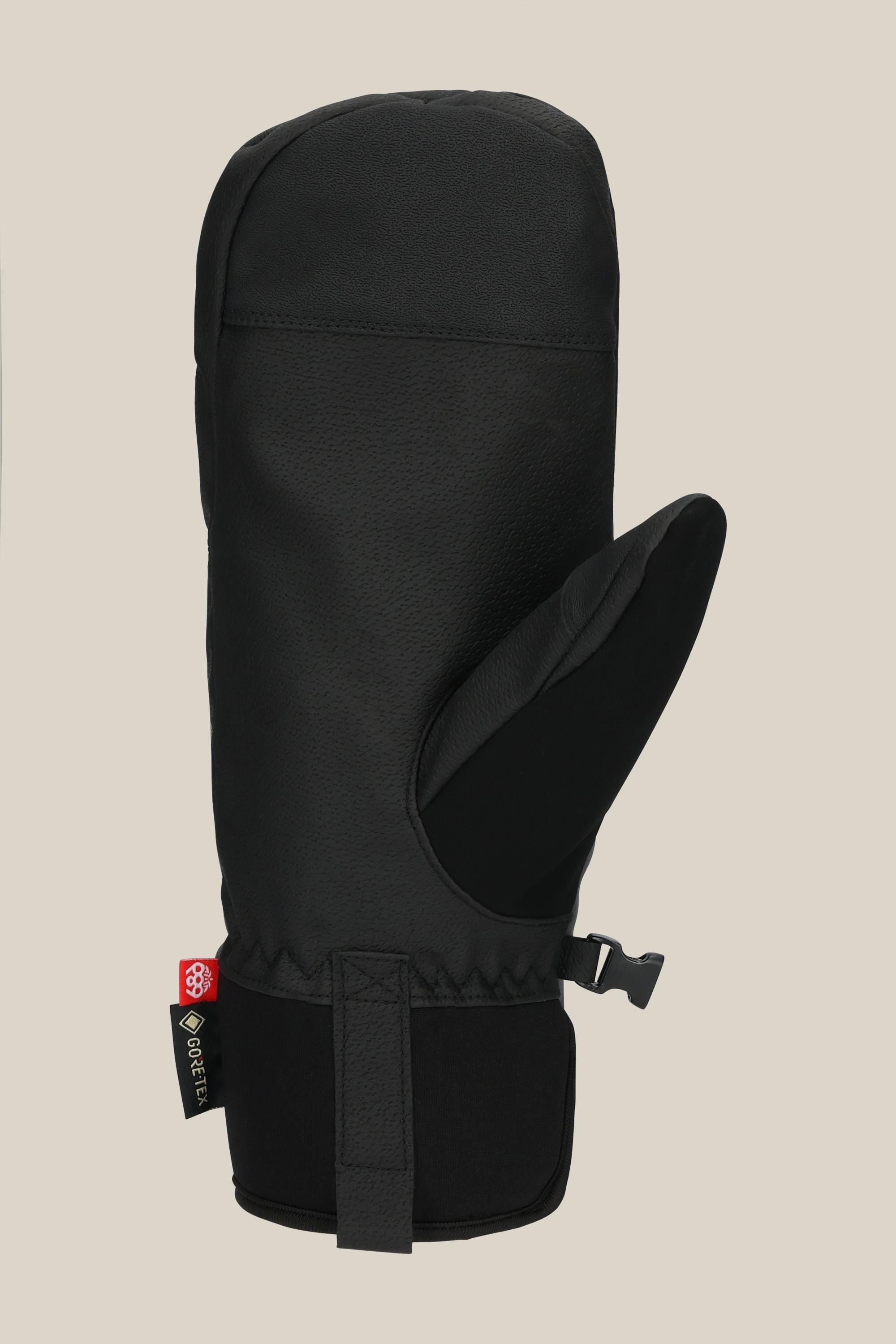 The 686 Mens GORE-TEX Linear Under Cuff Mitt by 686 is a black insulated PU mitt featuring a velcro wrist strap, side clip, and GORE-TEX tag, displayed on a plain beige background.