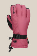 The 686 Womens GORE-TEX Linear Glove features a pink insulated design with black accents, an adjustable strap, GORE-TEX label, and the 686 logo by the wrist, shown against a beige background.