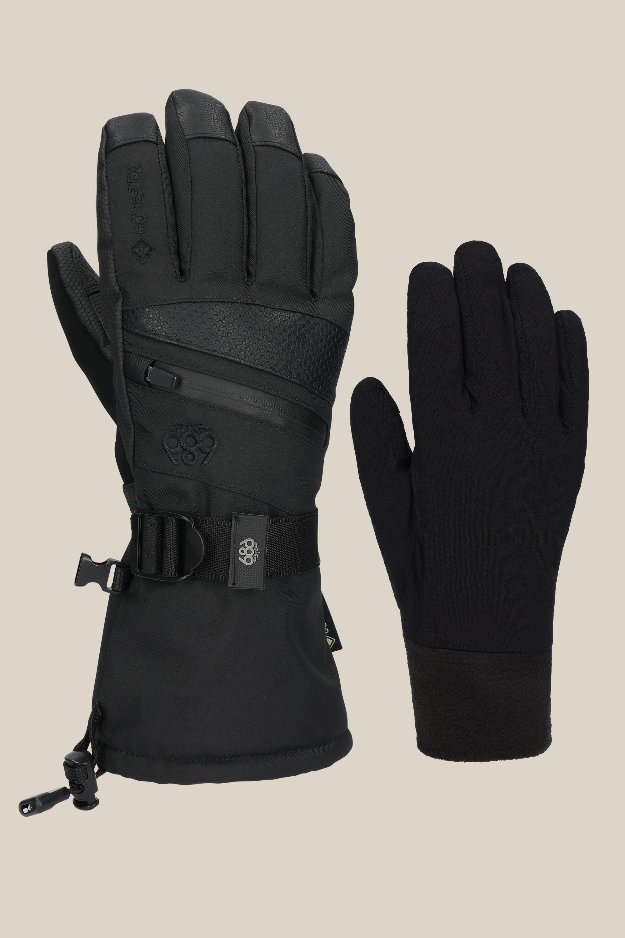 Two black womens gloves by 686: the GORE-TEX Smarty 3-In-1 Gauntlet Glove, thick and insulated with a zipper and strap, and a thin plain PU glove. Both are displayed on a neutral background showing palms and backs.