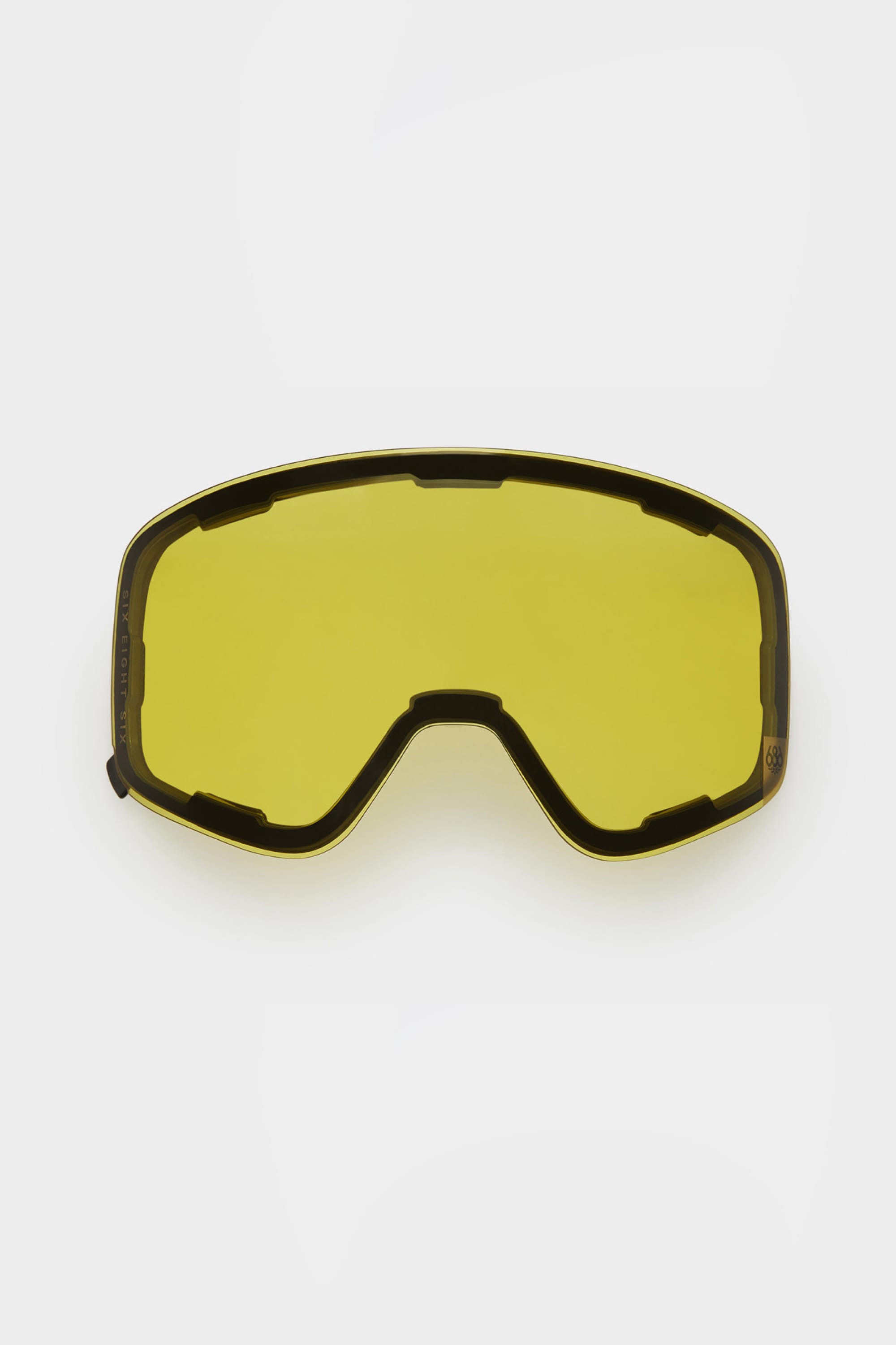 The 686 SMARTY Magnetic Goggle Replacement Lens by 686 is a yellow-tinted, curved lens with top and side cutouts. Designed for easy swapping, its shown on a plain white background and fits most ski or snowboard goggles.