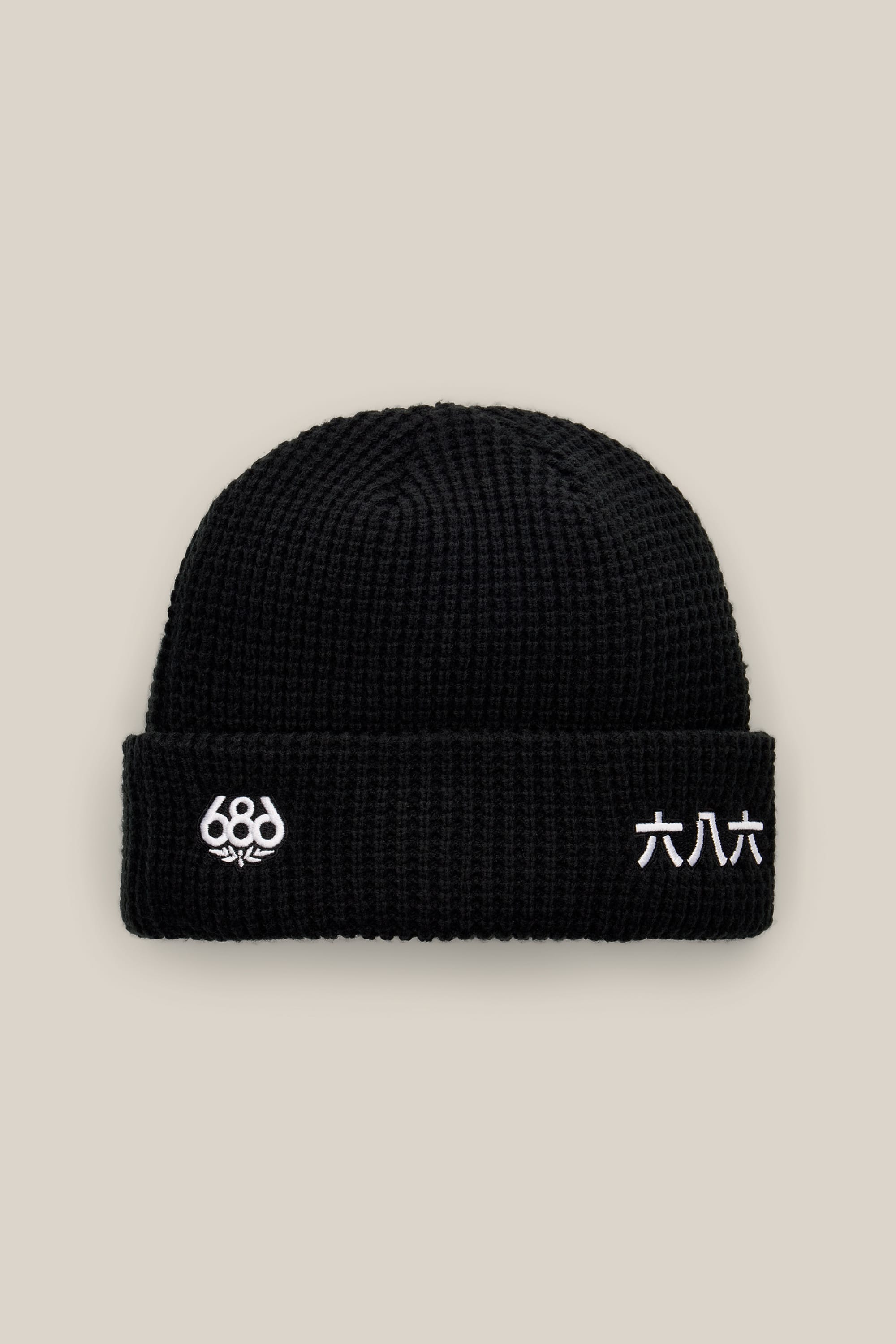 The 686 Kanji Beanie by 686 features a black acrylic knit design with white embroidered details—‘686’ on the left and Japanese kanji characters on the right—displayed against a neutral background. This men’s beanie seamlessly blends modern style with timeless comfort.