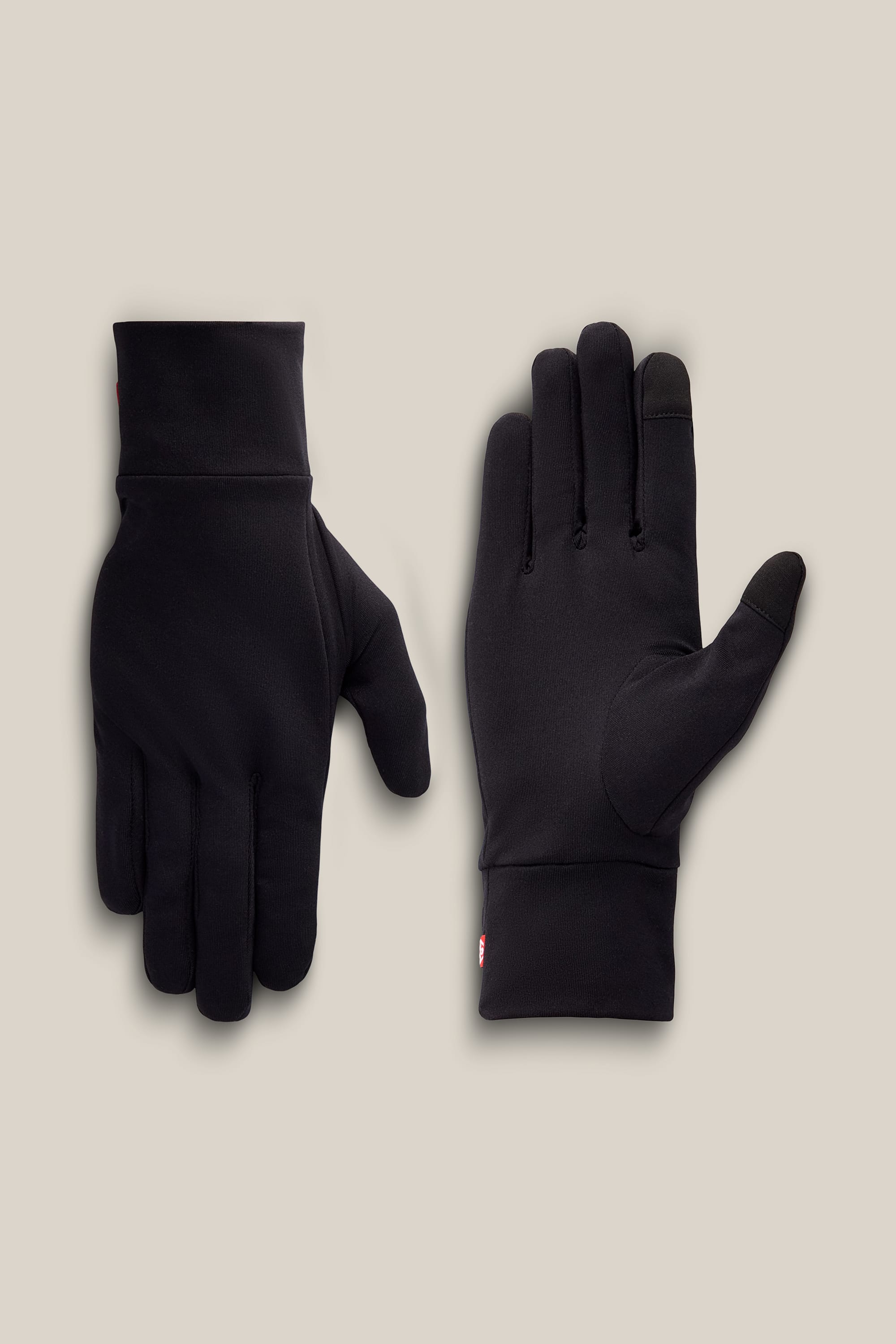 A pair of 686 Men’s Fleece Glove Liners is displayed on a neutral background, one showing the palm side and the other showing the back; both gloves are empty and laid flat.