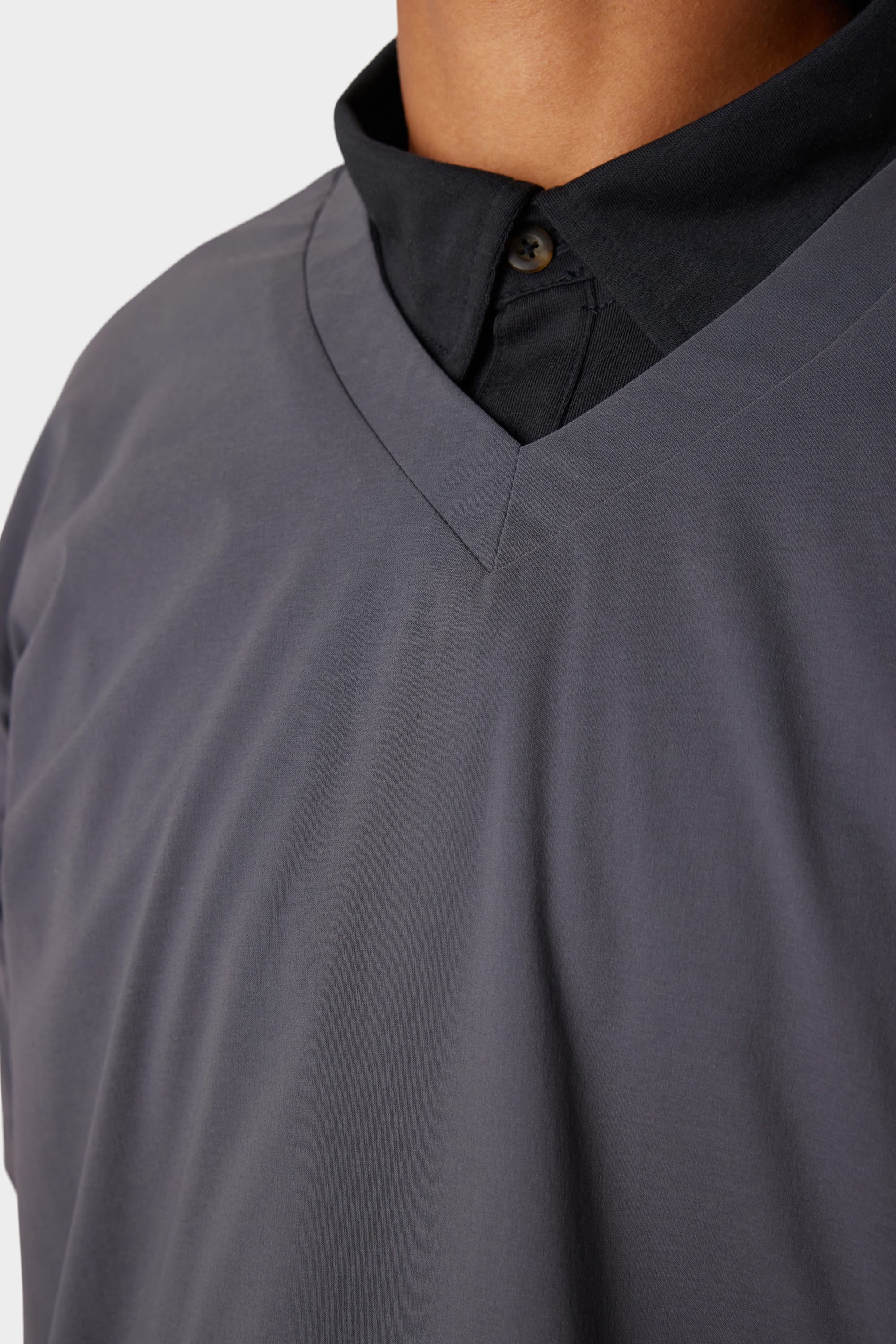 Close-up of a person wearing the 686 x Malbon Mens PrimaLoft drirelease® Merino-Lined Pullover Jacket, shown from the shoulders to mid-chest.
