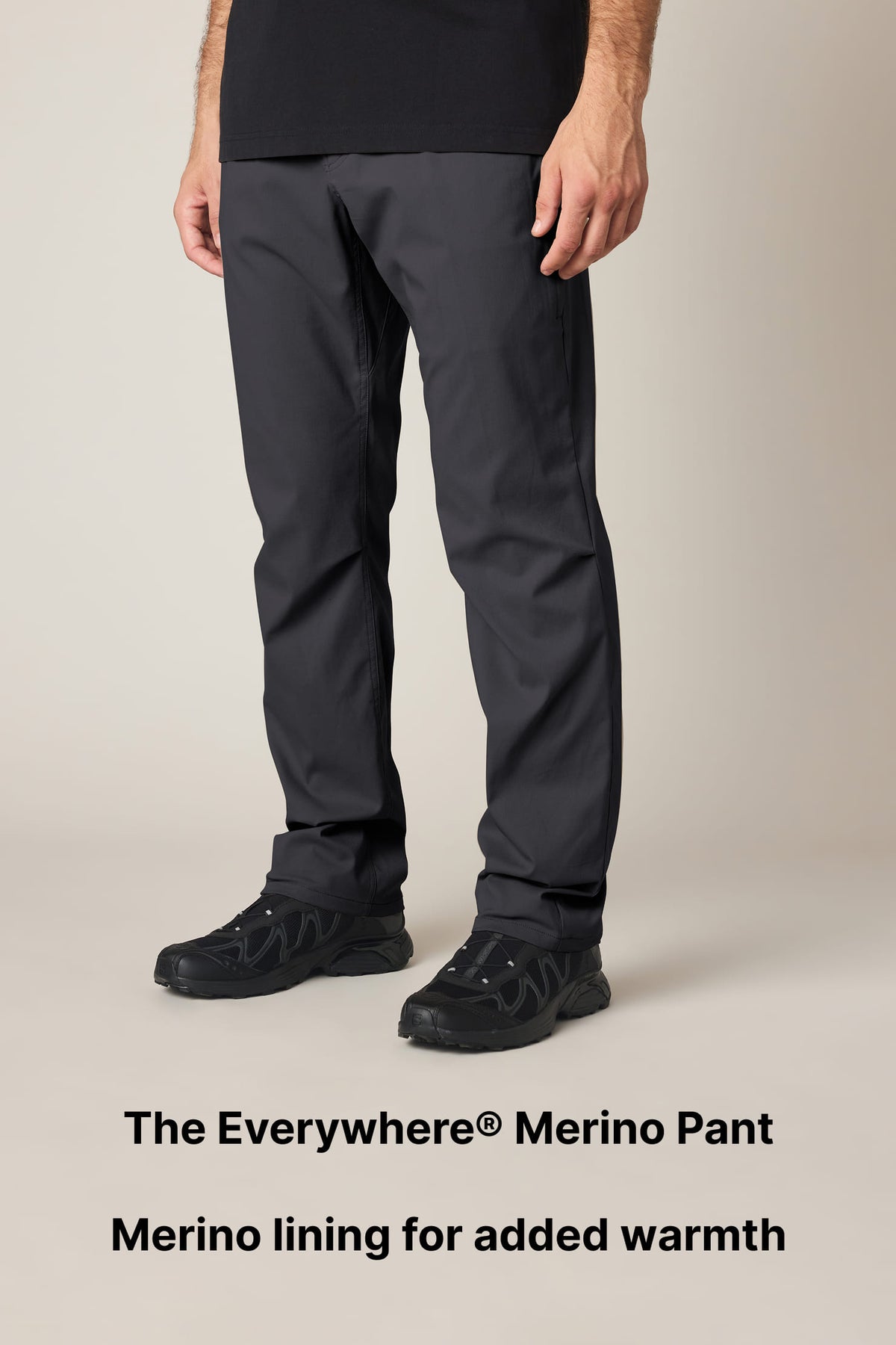A person wears black pants and black sneakers. Text below reads: The Everywhere Merino Pant. Merino lining for added warmth. The pants look casual and comfortable.