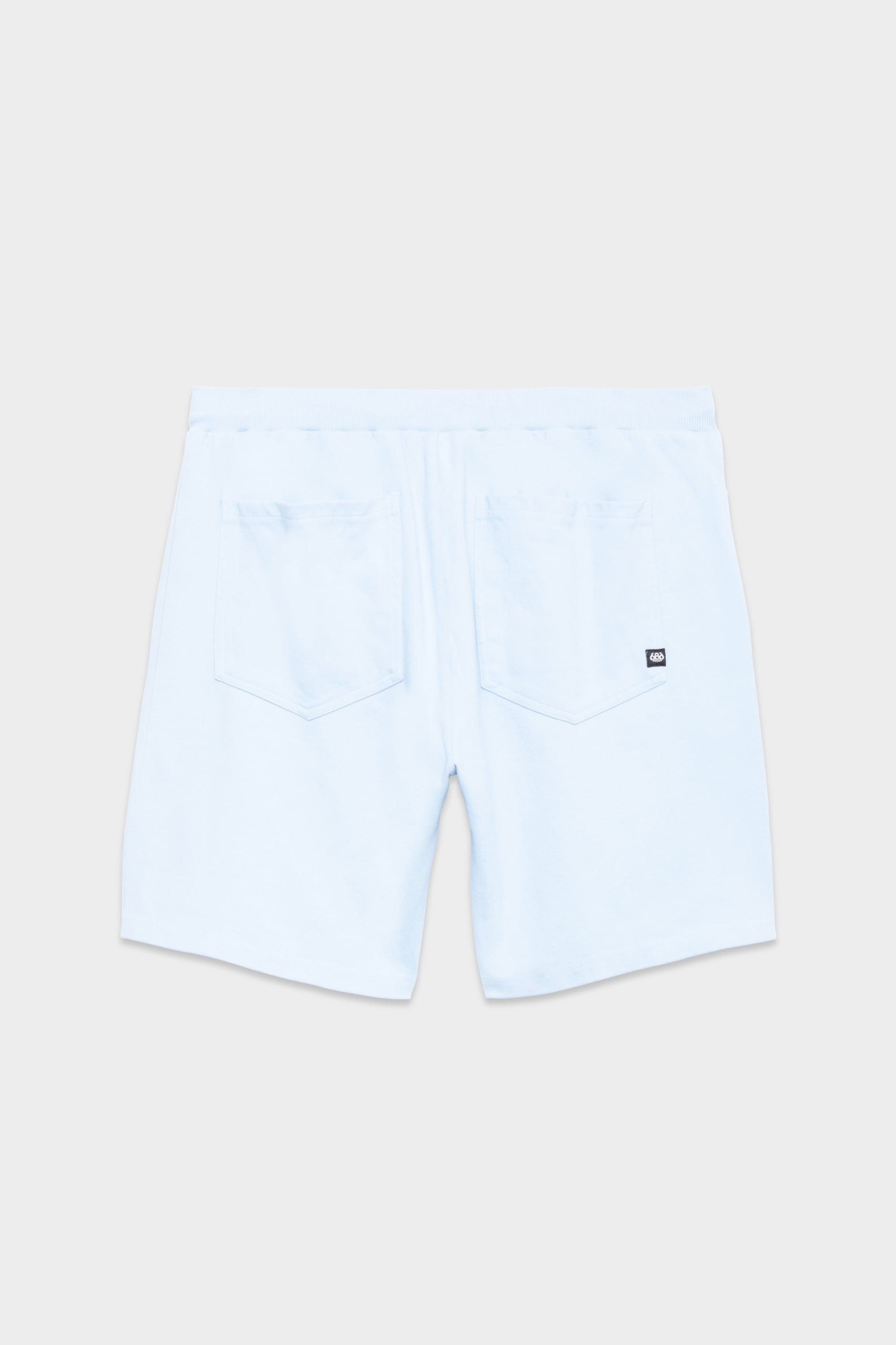 The 686 Mens Everywhere Double Knit Short in light blue is shown from the back, with two back pockets and a black-and-white logo tag on the right pocket, set against a plain light background.