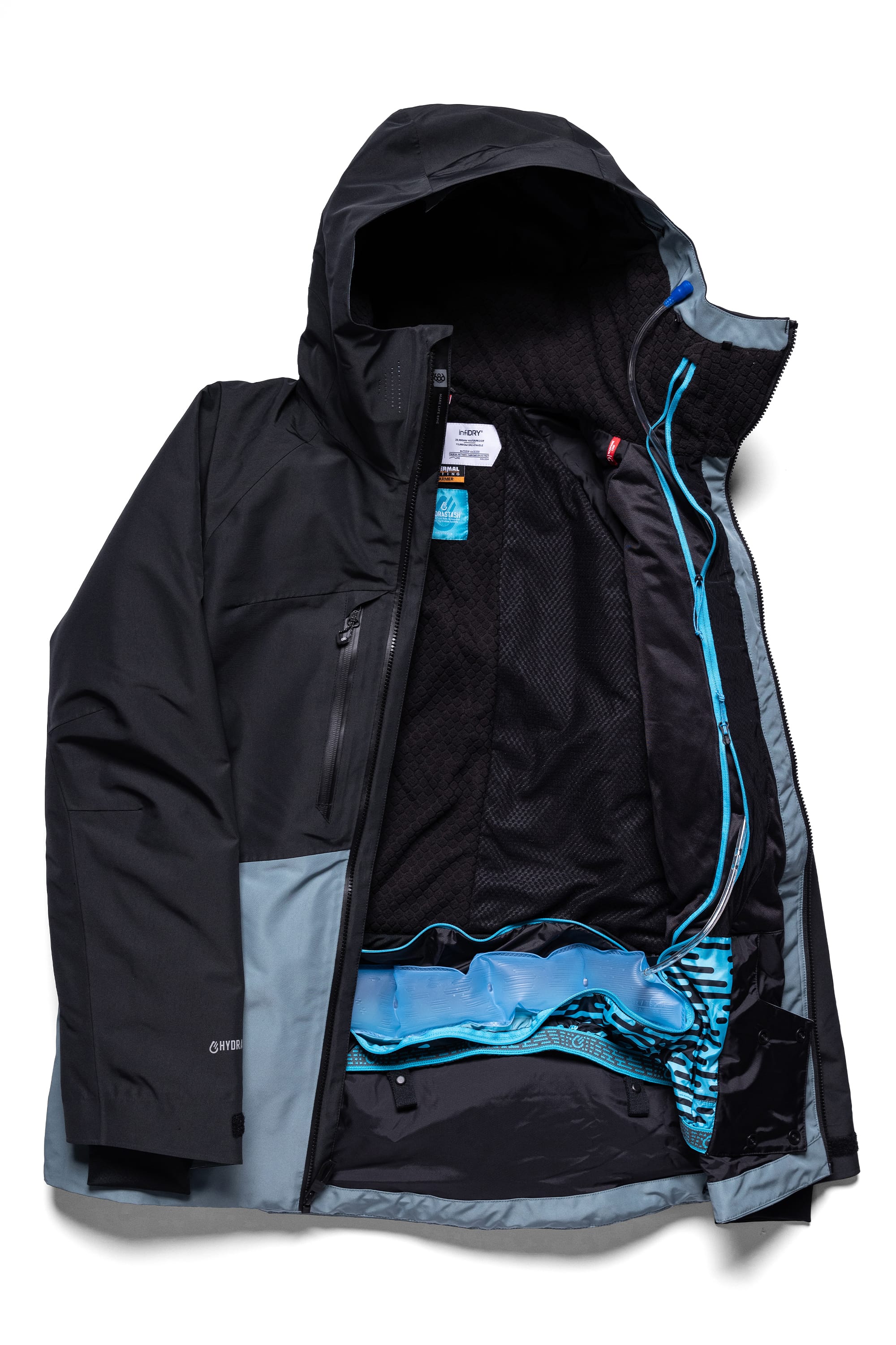 The 686 Men's Hydrastash Reserve Insulated Jacket by 686 is laid flat, unzipped to reveal its mesh-lined interior, inner pockets, and blue accents along the zipper and waistband.